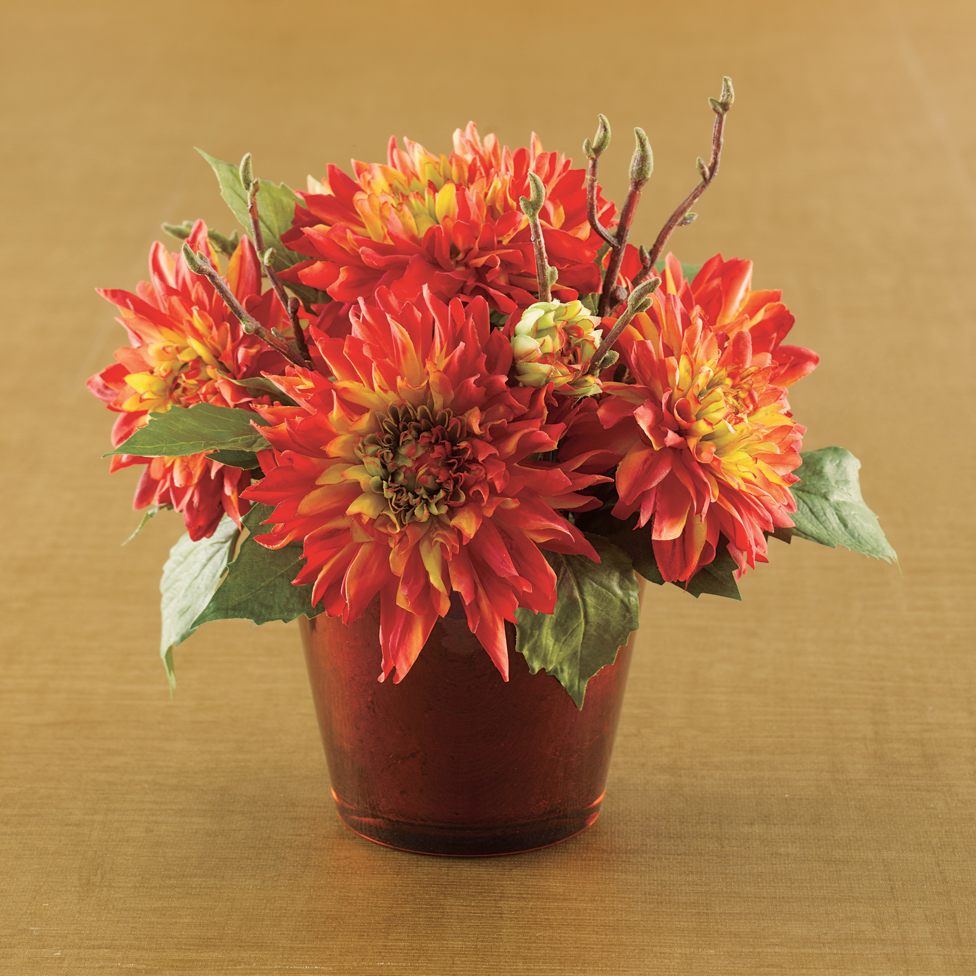 RED/ORANGE DAHLIAS IN RED GLASS VASE
