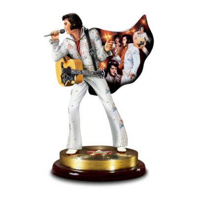 The costumes and clothing Elvis Presley&reg; wore throughout his legendary career said as much about this brilliant performer as his music and shows; Elvis was always dressed for success. The Sensation is a fabulously lifelike sculpture that vividly recalls The King of Rock 'n' Roll&reg; in one of his many dazzling jumpsuits, originally designed by Bill Belew, with a flowing cape emblazoned with montage of the portrayals of Elvis&reg; by artist Bruce Emmett.This exclusive Elvis Presley tribute figurine exclusively from The Bradford Exchange is hand-cast and hand painted to highlight every exquisite detail of the guitar and jumpsuit. Through this lifelike sculpted musical figurine you can almost see Elvis once again strut across the stage while it plays the hit Elvis melody "Hound Dog." Legions of Elvis fans will create strong demand for this Elvis memorabilia collectible. Order now!