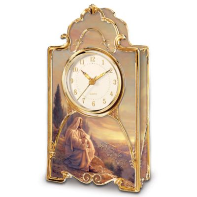Celebrate the gift of Christ's love for all time with this limited-edition inspirational Christian clock, available exclusively from The Bradford Exchange. For the first time ever, acclaimed artist Greg Olsen's moving Christ portraiture is showcased on a 22K gold and fine porcelain Christian collectible mantle clock, an uplifting work of religious home decor you will treasure forever.Expertly crafted of fine porcelain and lavished with gleaming 22K gold, this Christian collectible clock glows with Mr. Olsen's moving vision of Christ sitting in the hills above Jerusalem watching over his flock. His words, "I am with you always," shimmer in golden script. The classic porcelain clock face is highlighted by elegant golden numerals and golden hands powered by a precise quartz movement. Imagine the joy this decorative inspirational clock will bring to every moment of your day, but don't delay! Strong demand is expected - order now!