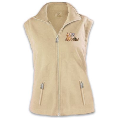 Cat lovers know there's nothing quite as cozy as a warm kitty. Now you can snuggle up to that same heartwarming comfort every time you wear this stylish kitten-themed apparel, an exclusive design from The Bradford Exchange. Slip into the feline luxury of this natural beige color fleece vest, adorned with whimsical embroidered kitten artwork from internationally famed painter and collectibles artist Jurgen Scholz. Expertly fashioned of high-quality mid-weight fleece, this delightful kitten-themed apparel for women features a flattering fitted cut, and a collar that can be worn up or down. For extra purr-sonality, two zippered pockets and the center zipper all close with matching sculptural kitten-shaped pulls. Keep snug as a kitty-cat on any brisk day, or give it to someone special as a purr-fect cat lovers gift. Strong demand is expected. Order now!