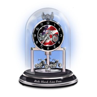 Hop on a chopper, fly across an American highway and you're sure to feel exhilarated! Now, enjoy a first-ever collectible motorcycle themed clock to unite rotating sculptures of motorcycles with symbols of American pride. The clock's design is inspired by anniversary style clocks American GIs brought back as World War II souvenirs.Live free and hard with this limited-edition motorcycle themed clock, only from The Bradford Exchange. The clock face is decorated with renowned artist Marc Lacourciere's portrait of a classic chopper and Old Glory. Three chopper sculptures rotate around the clock's porcelain base, an eagle sculpture adorns the top and the clock is encased within a glass dome. A unique keepsake or makes an ideal gift for bikers. This handcrafted timepiece is expected to generate strong demand. Don't miss out - order now!