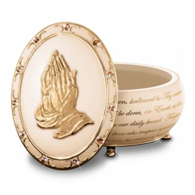 Knowing that your cares are in the hands of the Lord brings great comfort and peace. Now you can embrace your faith through the power of prayer with this limited-edition Heirloom Porcelain&reg; prayer music box, exclusively from The Bradford Exchange. This collectible music box will lift your spirits as it plays the melody, "The Lord's Prayer."This inspiring prayer music box, "The Lord's Prayer," is crafted of Heirloom Porcelain&reg; with gold-enhanced feet and features the enduring image of the "The Praying Hands" in a bas-relief sculpture adorned with gold. A continuous script of "The Lord's Prayer," Swarovski crystals and 22K gold accents add more delight. Plus, this meaningful collectible comes with slips of parchment paper to write your personal prayers and store them inside the box. Makes a thoughtful religious gift. High demand is expected. Order now!California Residents click here for Proposition 65 notice.