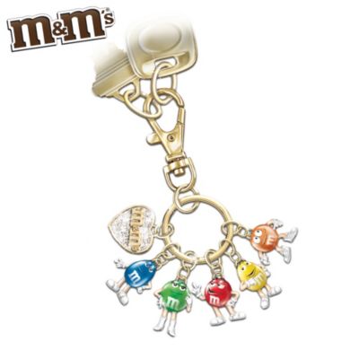 Confident Red, nutty Yellow, sassy Green, cool Blue or hyper Orange? Which M&M'S&reg; character matches your personality? Maybe you see a little bit of yourself in each! Now you can celebrate this friendly crew with this charming M&M'S characters collectible key chain, a fine jewelry exclusive from The Bradford Exchange.Finely handcrafted, this Swarovski crystal key chain features six delightful M&M'S charms. Five of the charms are everybody's favorite "candy-" coated handful, perfectly sculpted and accented with brightly colored enamel. The last charm is heart-shaped and adorned with pave-set clear Swarovski crystals and 24K gold plating. Plus, this adorable keepsake features a lobster-style clip to keep your treasured friends in style and secure. High demand is expected. Order now!California Residents click here for Proposition 65 notice.