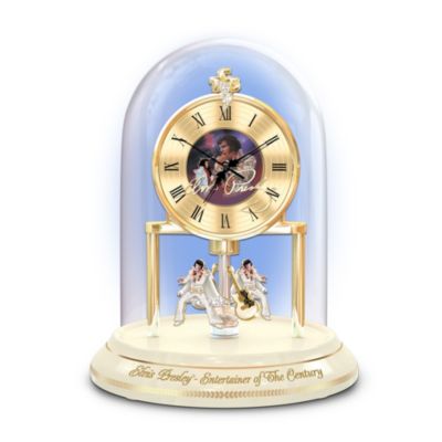 The King of Rock 'n' Roll&reg; rocked the stage and the hearts of a billion fans during his magical "Aloha from Hawaii" TV concert on January 14, 1973. Now you can celebrate the groundbreaking moment with this first-ever Elvis Presley&reg; clock commemorating the 35th anniversary of his unforgettable performance, a limited edition exclusively from The Bradford Exchange.Exquisitely handcrafted in porcelain, this stunning Elvis collectible clock features a record-shaped clock face with full-color art of Elvis by acclaimed artist Nate Giorgio and Elvis's TCB emblem sparkling with simulated gems. Below the clock is a pair of revolving hand-painted Elvis figures and two golden guitars to recall his amazing moves. Plus, this glorious scene is encased within a glass dome and rests atop an ivory porcelain base. Strong demand is expected. Order now!