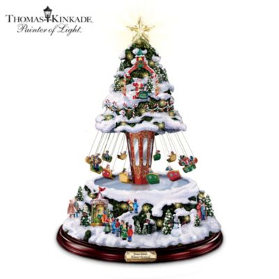 Long to rekindle memories of a carnival's breathtaking rides, crowds and bright lights? Recapture this all-around fun with a collectible Thomas Kinkade tabletop tree combining colorful lights, holiday tunes and a working sky swing that spins in the center of tree - a Bradford Exchange exclusive.Step right up to enjoy the Painter of Light's enchanting vision of a gala celebration with this handcrafted, hand-painted Thomas Kinkade Christmas decor. At the flip of a switch, the 12 intricate cars on the sky swing spin in merry rotation, while a medley of eight beloved holiday tunes plays and 12 golden LED lights and a glowing crystalline star topper illuminate the scene. Reflective panels on the tree's gaily decorated center column recapture the charms of a carnival from days gone by. This snow-covered wonderland features a handsome wooden base and name plaque for fanciful finishing touches. High-flying demand is expected for this limited-edition Kinkade holiday decoration. Don't miss out - order now!