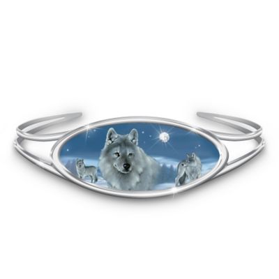 Striking, alluring and captivating - the majestic silver wolf is forever a breathtaking wonder of nature. Now you can cherish this magnificent creature wherever you go with a stunning wolf art Swarovski crystal bracelet, a fine jewelry design exclusively from The Bradford Exchange. You won't want to miss this first-ever treasure created with wildlife art by acclaimed artist Eddie LePage!Finely handcrafted and plated in sterling silver, this gleaming bracelet features enchanting wolf art imagery by Eddie LePage on an oval inlay. A brilliant moon handset with a genuine Swarovski crystal adds delight as a sterling silver-plated frame surrounds the glorious full-color scene. Plus, this magical treasure arrives in a custom designed presentation case, perfect for safekeeping. High demand is expected. Order now!California Residents click here for Proposition 65 notice.