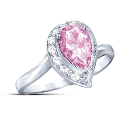 Take a sparkling journey of romantic love that only gets more wonderful as life goes on. This stunning pink topaz ring celebrates that journey as never before, in a fine jewelry exclusive design from The Bradford Exchange. The rosy, romantic color and meaningful design of this pink topaz women's journey ring make the light of love sparkle and shine right on your finger with every wearing! And there's even an elegant engraved message added to this unique design, to remind you of the endless love you both share.This stunning women's journey ring is handcrafted in solid sterling silver and features a dazzling pear-shaped pink topaz, over a full carat in size, at the center of the design. This impressive stone is surrounded by 8 sparkling white topaz stones in a fashionable "journey" setting, with the stones increasing in size as they lead to the romantic engraved inscription: "Love Always". This exclusive pink topaz ring arrives in a custom-crafted presentation case, making it perfect as a personal treasure or an unforgettable gift. A ring this richly romantic is sure to create strong demand, so don't wait. Order now!