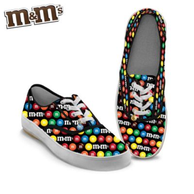 It's time to get walking in a sweet treat for your feet! Celebrate everyone's favorite candy-coated delectable with these officially licensed, high-quality M&M'S&reg; shoes. Your love for the popular candy and your flair for fashion unite in these colorful women's sneakers, available in a first-of-a-kind design exclusively from The Bradford Exchange. Turn every step into "eye-candy" when you slip into this M&M'S apparel, featuring a rainbow of colorful imagery across the cotton canvas stitched upper. And make no sacrifices on comfort when you are cradled in the support of their firm rubber soles and soft foam insoles. There is even a sparkling blue M&M'S charm on the lace of each shoe to add a dazzling finishing touch! For style that never looked so sweet, DON'T WAIT to get yours. Order now!