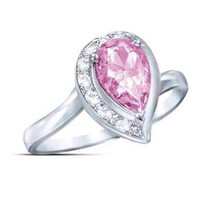 The power of pink comes to fashion jewelry in this stunning topaz journey ring! With its impressively sized pear-shaped pink topaz, this ring is deliciously indulgent and sure to turn heads wherever you wear it! The truly stunning pink topaz gemstone is surrounded by a sparkling "journey" setting of white topaz stones, in a fine jewelry exclusive from The Bradford Exchange that sends an unmistakably romantic message.Expertly handcrafted in solid sterling silver, this topaz journey ring features a genuine pear-shaped pink topaz over 1 full carat in size. The exquisite pink gemstone is cradled in a dramatic setting with 8 sparkling white topaz stones in the popular "journey" style, gradually increasing in size to symbolize a love that grows stronger over time. This exclusive, pink and white topaz ring arrives in a custom jeweler's case, making an unforgettable gift for any woman. Romance is forever in the pink with this fabulous topaz journey ring and strong demand is expected, so don't wait. Order now!
