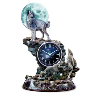 Step out into the wild and experience the haunting beauty of wolves like never before. The majesty of a moonlit moment is captured in time with this first-of-its-kind glow-in-the-dark sculpted wolf clock, available exclusively from The Bradford Exchange. Featuring the best-selling imagery of famed wildlife artist Vivi Crandall on its face, this dramatic tabletop clock makes every hour an "Hour of Twilight."Handcrafted in artist's resin, three hand-painted wolves in action explore their rocky terrain under the full moon, for a stunningly lifelike work of home decor. And simply expose your sculpted wolf clock to light, and the moon, clock hands and numbers will all glow with a breathtaking luminous effect. But hurry! This powerful precision quartz tabletop clock is a limited edition and expected to generate heavy demand, and you don't want to miss out. Order now!