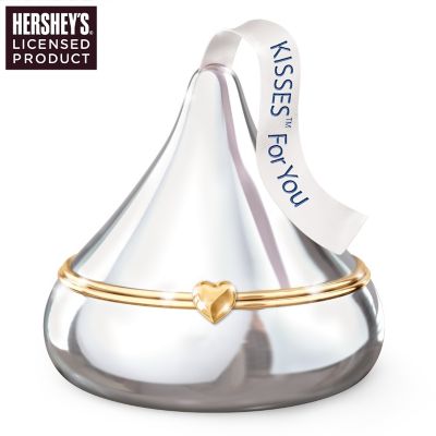 Show your sweetie just how sweet she is with this collectible HERSHEY&reg;'S KISSES&reg; For You Heirloom Porcelain&reg; music box exclusively from The Bradford Exchange. Handcrafted of lustrous, triple-fired Heirloom Porcelain, this Limoges-style music box boasts a silvery "wrapper" and white plume inscribed with the words "KISSES For You." Show your special someone how dear she is with this enchanting HERSHEY'S KISSES collectible. This limited-edition music box opens on a gleaming, golden heart-shaped clasp to reveal a musical movement that plays the beloved melody "You Are So Beautiful." Strong demand is expected for this everlasting "treat" that makes a unique gift for someone special. Don't miss out - order now!