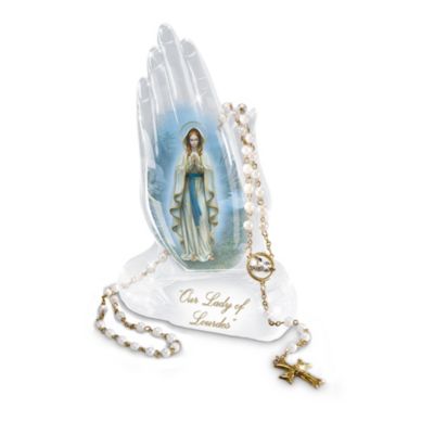 Mary's eternal devotion to our needs is a gift beyond compare. Now, you can celebrate this blessing from above with a stunning Our Lady of Lourdes praying hands figurine, a limited edition available exclusively from The Bradford Exchange.Handcrafted of glistening crystalline, this inspiring collectible features realistically-detailed, delicate hands gently clasped and raised toward the heavens in solemn prayer. Gracing the front of the hands is a beautiful image of our Lady's apparition to St. Bernadette as envisioned by famed artist Hector Garrido. Plus, this religious treasure includes a FREE gold-plated rosary with 60 pearlescent beads, a detailed dove medallion and a gleaming crucifix. Makes a meaningful Our Lady of Lourdes gift, but strong demand is expected. Order now!