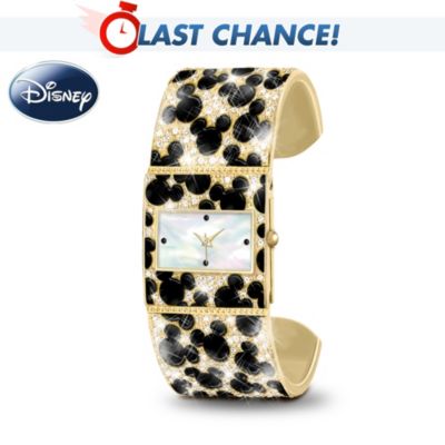 There's always room to add some Mickey magic to your wardrobe! Celebrate this beloved Disney favorite in show-stopping style when you wear the "Discover the Magic" Mickey Mouse watch, a cuff watch design available specially from The Bradford Exchange.This fashionable handcrafted cuff watch features a rectangular timepiece with a luminous mother-of-pearl watch face. The adjustable bracelet's unique design features black enamel silhouettes of Mickey's face and ears "hiding" in an animal-print style pattern that is surrounded by over 300 sparkling crystals. The reverse side of the watch face is finely etched with Mickey's silhouette and "Timeless Magic". High demand from Mickey Mouse collectors and enthusiasts is expected, so don't delay. Order now!California Residents click here for Proposition 65 notice. This fine watch is intended for adults.
