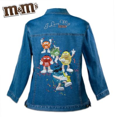 There's nothing quite like indulging in a favorite treat like the irresistible M&M'S&reg; candies. Now all the sweetness of this beloved candy and all the personality of the charming M&M'S Characters inspire the Sweet Celebration women's denim jacket, a fashion design debut available only from The Bradford Exchange. Captured on the back of this classic M&M'S jacket is a vivid portrait of Green, Red, Blue, Yellow and Orange, and the message "I Love My M&M'S," all presented in detailed appliqué and embroidery.Tailored of durable, dark-wash medium-weight denim, this custom-designed M&M'S apparel is comfortable and versatile enough to wear anywhere. It features a figure-flattering cut with two front pockets and colorful M&M'S buttons. Plus, the M&M'S Characters on the back are enhanced with shimmering embellishments for an even sweeter dazzle. Don't miss your chance to step out in the truly tempting style of M&M'S. Order now!