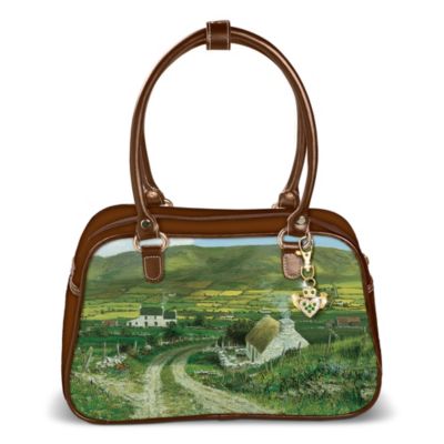 No need to dream about the Irish countryside - take it with you when you carry this fashionable Irish purse. Share the luck of the Irish everywhere you go with this Irish handbag showcasing beautiful imagery of the Ireland countryside by acclaimed artist Edmund Sullivan. This functional handbag features rich, chocolate brown leather trim and handles, metal rings, a spacious main compartment that zips closed to keep your valuables secure and 3 interior pockets to hold all your essentials.  This fashionable work of art is handcrafted of twill polyester and exclusively from Bradford Exchange. It comes with a FREE detachable sculpted Claddagh keychain that is embellished with sparkling green simulated jewels. You'll be transported to the Emerald Isle every time you look at the lush art on this striking handbag. Strong demand is expected, so order now!