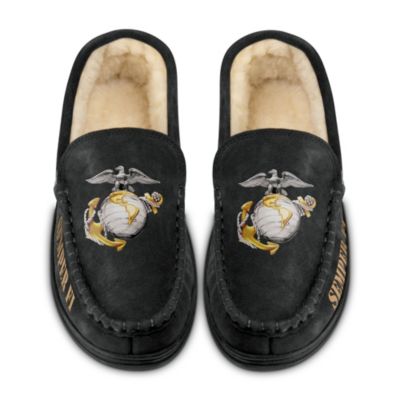 In the air, on land and on sea, the United States Marines are always there, ready to serve. There is no doubt that The Corps has certainly earned the right to walk proudly no matter where they go. Now those always faithful Marines and all those who support them can express that honorable and enduring sprit with these custom-designed USMC moccasins for men, available exclusively from The Bradford Exchange.Handcrafted of black suede uppers and durable rubber soles, these Marine Corps moccasins are versatile enough to wear as slippers or shoes, and they are lined with plush faux shearling for ultimate comfort. The USMC eagle, globe and anchor emblem embellishes the top of each moccasin, with "Semper Fi" in gold lettering along the sides. Put your best foot forward when you step out in these bold USMC moccasins; they also make an impressive Marine Corps gift too. Don't wait to secure yours - order now!