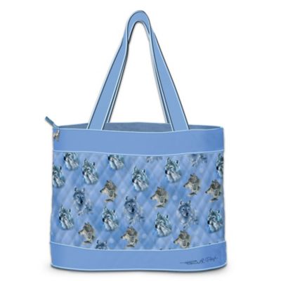 Wolves have a majestic beauty, untamed spirit and loyal nature! You can celebrate the Spirit of the Wilderness that they embody with this wolf tote bag. This designer-style tote is crafted of imported, soft quilted fabric in slate blue with a striking montage of acclaimed artist Eddie LePage's famed wolf art portraits. A replica of the master artist's signature adorns the bottom of the bag.  You'll love this go-anywhere quilted tote bag that combines fashion and function, and is exclusively from The Bradford Exchange. It features comfortable straps, a roomy interior with a zippered closure to keep your valuables secure, along with two inside pockets to help you stay organized. A sculpted metal wolf charm suspends from the zipper. It even comes with 2 FREE matching cosmetic cases, each crafted of soft quilted fabric with zippered closures. Strong demand is expected, so order now!