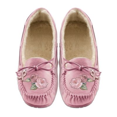 Take steps to fight breast cancer with every stride you take, when you wear these pink suede moccasins that show your commitment to the cause. These Steps Toward A Cure genuine suede women's moccasins are a first-of-its-kind available only from The Bradford Exchange. Featuring elegant floral embroidery inspired by the hope that blooms in our hearts for an end to breast cancer, this fashionable footwear makes a difference because a portion of the proceeds from the sale of these moccasins supports the fight against breast cancer.Lined with plush faux shearling for cozy comfort and warmth, these genuine suede women's moccasins have durable rubber soles for wear-anywhere versatility. With elegantly embroidered pink roses on the top of each moccasin, and a pink awareness-ribbon charm tied to the laces, there's no doubt that this pair of pink suede moccasins makes a fashion statement that you can feel good about. Women everywhere who feel strongly about the fight against breast cancer will be taking steps to get these exclusive moccasins, so don't wait. Order now!