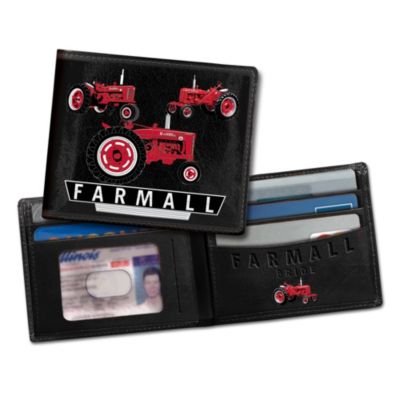 American farmers relied on Farmall tractors as their trusty workhorse for decades and the Farmall brand has represented a piece of the rich American agricultural history. Now you can unfold a celebration for the tractor that helped grow America.You're sure to show your Farmall pride with this striking men's leather wallet crafted of rich, black leather that is supple, yet rugged for long-lasting wear. On its cover are bold, full-color art of classic Farmall tractors - symbolic of this American farm legend. Inside is more artwork as well as the Farmall logo, which is embossed beautifully into the leather. Plus, this keepsake includes ample pockets for cash and cards and a clear ID window for convenience. Makes a perfect gift for any tractor lover, but strong demand is expected. Order now!