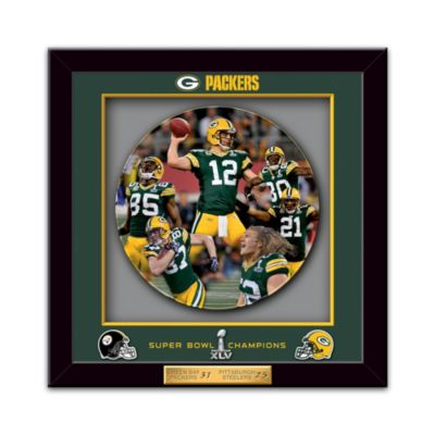 The beloved Green Bay Packers certainly have something to celebrate! They brought home their fourth championship title with a dramatic win at Super Bowl XLV, and now you can forever commemorate their epic victory with a limited-edition Green Bay Packers shadowbox plate, available exclusively from The Bradford Exchange. This officially-licensed museum-quality Green Bay Packers Super Bowl collectible has a limited edition of only 4,500, making it a must-have for any Packers fan.Exciting full-color Super Bowl XLV actual game photography marks an attractive center plate, framed within a handsome recessed image shadowbox. With its crystal-clear museum-quality cover, your Green Bay Packers shadowbox plate dramatically captures depth of field and rich visual dimensions. The collector plate is surrounded by archival-quality matting, while the frame is emblazoned with official Packers and Super Bowl XLV logos, and team helmets; there is even a golden score plaque as a perfect finishing touch. But don't wait to secure yours, as this limited-edition Green Bay Packers Super Bowl collectible will soon be gone. Don't wait - order now!
