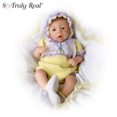 This adorable 18-inch lifelike baby doll has a soft body just made to pose and pamper. She's a cuddle bug, too, with arms, legs and head crafted of soft RealTouch vinyl. What's more, her specially-designed sleep eyes are calibrated to close with a slow, natural action every time you lay her down!Enjoy a heaven-sent bundle of joy with this charming vinyl baby doll, by famed doll artist Sheila Michael and an Ashton-Drake Galleries exclusive. Doll is outfitted in a beautiful heirloom-quality ensemble that includes a matching cap and booties, all made with the finest materials available. This loving little package is expected to generate exceptional demand. Don't miss out - order now!