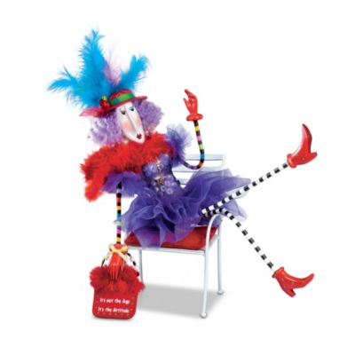 Look out, world! The first-ever collectible Dolly Mama's age humor doll is here to remind you that when it comes to enjoying life, attitude trumps age every time! This Dolly Mama's doll has all the style and sass of artist Joey Heiberg's beloved Dolly Mama's characters, including frills and feathers to the max, plus a FREE coordinating miniature chair so you can pose her to express your own mood!This fabulous, Dolly Mama's doll is available only from The Ashton-Drake Galleries. She has hand-painted features and bendable arms and legs for lots of fun poses. From the top of her outrageous feathered hat to the tips of her polka- dot boots, she's woman to be reckoned with, and her handbag says it all: It's Not the Age, It's the Attitude. This age humor doll will brighten your own life, and makes a great tongue-in-cheek gift for mom, sis or a good friend. You don't want to miss out, so order now!