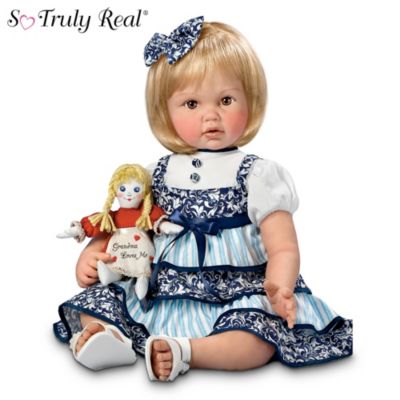 It's always fun to take a stroll down memory lane with Grandma - you never know what you might find! Experience the joy of sharing memories with someone you love with this charming collectible granddaughter doll by award-winning doll artist Cheryl Hill. This Aston-Drake Galleries exclusive is a So Truly Real&reg; toddler doll featuring RealTouch vinyl skin, tiny painted toe nails, and inset eyes to perfectly capture her wide-eyed curiosity.At 22", she's just the right size to hold that special rag doll Grammy has been saving for her. Her dress is beautifully tailored in French country style, accented with ruffles, ribbons, and cloth-covered buttons with a matching hair bow for her pretty blonde hair. Her precious baby doll in a "Grandma Loves Me" dress is as perfect in every detail as the little one who holds her. High demand is expected for this masterpiece by Cheryl Hill, so don't delay. Order now!