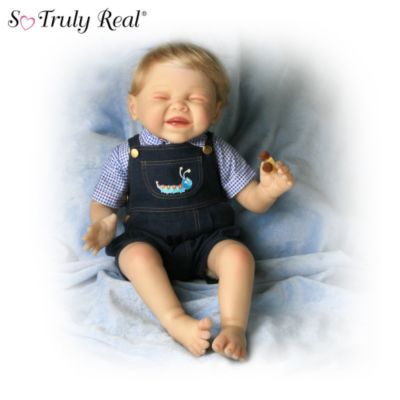 This curious little boy reacts to his fuzzy little garden friend with lots of smiles becauseit tickles! Created by noted doll artist Bonnie Chyle, famous for her expressive sculpting, this remarkably lifelike baby doll is a So Truly Real&reg; Ashton-Drake Galleries exclusive. He's sure to make you smile right back with his adorable pose, irresistible expression and specially designed costuming. And of course, he comes complete with his fuzzy caterpillar friend to make the scene seem so real!This lifelike baby doll is meticulously sculpted by the artist, then handcrafted in RealTouch&reg; vinyl, and hand-painted to capture every detail of his "tickled" expression. He has baby-fine hair and hand-painted fingernails and toenails, too. This adorably realistic baby doll comes dressed for play in a denim outfit with a caterpillar applique on the front and a matching checked shirt. Because baby dolls with this level of lifelike expression and costume detail are prized by collectors, demand is likely to be high for this little boy and his fuzzy discovery. So be sure to order now!