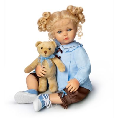It didn't take Sophie long to fall in love with her new best friend! This lifelike baby doll cherishes her teddy companion because he's soft, cuddly - and a good listener, too! Created by doll artist Barry Cathers, Sophie is an Ashton-Drake Galleries exclusive, sure to win your heart with her realistic baby doll look and her specially designed costuming. And of course, she comes complete with her teddy bear to keep a very special childhood friendship alive.This lifelike baby doll is crafted of soft vinyl with a cloth body. She has big blue eyes and her beautiful blonde curls are pulled up into the most adorable pigtails! Sophie wears a stylish outfit of cotton chintz with coordinating trims and ruffles. She's as sweet as they come, and demand is likely to be high. So be sure to order now!