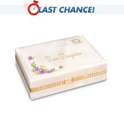 Give your darling daughter all your love with this collectible porcelain music box, shaped like a heartfelt letter from you! Available only from Ardleigh Elliott, this music box is inspired by the loving letters shared between mothers and daughters. It's handcrafted of Heirloom Porcelain??, and plays "You Are the Sunshine of My Life", creating a love musical note that lasts forever! Look at all the details of this limited-edition music box: the delicate violet motif, the letter-shaped clasp, the postmark, the floral stamp and special delivery mark. And there's the start of a sweet message, "Dear Daughter," in 22K-gold script! Lift the lid and find the rest of the message inside! Go ahead, deliver the perfect gift for your daughter! Order now!