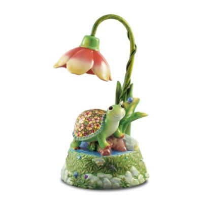 Louis Comfort Tiffany drew his greatest inspiration from nature when he crafted his iconic stained-glass treasures. Now a first-ever baby turtle lamp from Ardleigh Elliott combines the adorable charm of nature with a beautiful stained glass design. Daisy the turtle rests beneath an illuminated overarching blossom that shines down on her colorful shell in a musical collectible guaranteed to brighten your world. Meticulously handcrafted of fine Heirloom Porcelain&reg;, this baby turtle lamp is hand-painted in fine details to recreate a relaxing day in the meadow - complete with a friendly blue ladybug. Just flip a switch to cast an illuminating glow on Daisy's stained glass design shell and to hear the delightful melody of "You Are My Sunshine." Let this limited-edition musical lamp light up your day. Order now!