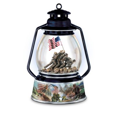 American heroes raising the flag on Iwo Jima is an iconic moment of American courage, strength, and honor. Now you can capture this shining legacy of the United States Marines with this illuminated USMC tribute music box. An Ardleigh Elliott exclusive, this keepsake highlights the storied history and exceptional bravery of World War II soldiers.The eye-catching centerpiece of this collectible music box is a handcrafted, hand-painted figure of Marines raising the flag at Iwo Jima, embraced by a hand-blown, glass globe. The inspiring scene rests atop a porcelain base in the shape of an antique lantern, encircled by panoramic imagery by artist Glen Green depicting victorious battles. Plus, this treasure plays "The Marines' Hymn." Peak demand is expected, so order now!