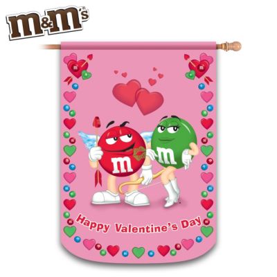 Are you ready for the sweetest Valentine's Day ever? Make it an M&M'S&reg; Valentine's Day when you display our exclusive M&M'S&reg; flag starring the characters "Red" and "Green", ready for romance! This charming M&M'S decor, available exclusively from The Hamilton Collection, is designed to display indoors or outdoors as a delightful addition to your home, and it's a great way to add some decorative style to this season of loving.Showcasing "Red" as a wishful Cupid and "Green" as his delectable lady love, this M&M'S Valentine's Day flag is waterproof, fade-resistant and machine washable, so the vivid colors and character illustrations will remain bright for years. The perfect message, "Happy Valentine's Day", and a decorative hearts-and-candies border make this seasonal indoor/outdoor M&M'S flag a sweet treat. What a great way to add a touch of chocolaty cheer to your Valentine's Day celebration! Strong demand is expected, so order now!
