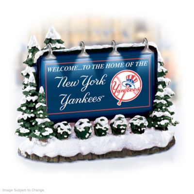 Now you can show your pride for the Major League Baseball&reg; club you love the most - just put its name up in lights with this New York Yankees&reg; village accessory! Officially licensed by Major League Baseball Properties and available from Hawthorne Village, this handcrafted New York Yankees billboard accessory is the perfect way to add color, drama and realism to your beloved New York Yankees village display!You'll love the way the four working billboard lights at the top illuminate the New York Yankees logo and bold club colors. And take a close look at all the detail in the surrounding snow-covered shrubs and trees - it's so realistic! Don't miss this must-have New York Yankees village collectible - order now!