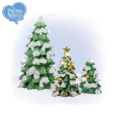 Nothing makes the holiday more beautiful than trees wearing their mantles of freshly fallen snow and decorated with brightly colored ornaments and gleaming garlands of gold. That's why these three Christmas tree Precious Moments&reg; Christmas village accessory figurines are the perfect way to enhance the look of your Precious Moments Christmas village display!Snow-kissed and festive - one even wears a golden star of peace - these Christmas tree Precious Moments Christmas village accessory figurines go a long way towards bringing more loving, caring, and sharing to your Precious Moments Christmas village. They're exactingly handcrafted and hand-painted and authenticated by Precious Moments creator Sam Butcher. Available exclusively from Hawthorne display, they bring joyous accents to your village display and make it more charming than ever. And you won't find a finer value anywhere, don't wait - order now!