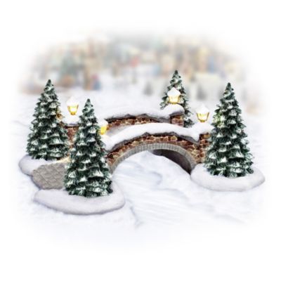 There's nothing more peaceful than walking across a cobblestone bridge dusted with newly fallen snow on a clear winter's day. Now, add the beauty and nostalgic charm of a cobblestone bridge to your beloved winter village display with this illuminated winter village accessory. It's the perfect way to add a warm glow and stir up wonderful winter memories - you can almost smell the fresh scent of pine!Available exclusively from Hawthorne Village, this collectible winter village accessory is meticulously handcrafted and hand-painted by master artisans. Four pretty lanterns set every snowy detail aglow, creating a special accent for any village display brimming with winter delights, so don't wait! You won't find a finer value anywhere. Order now!