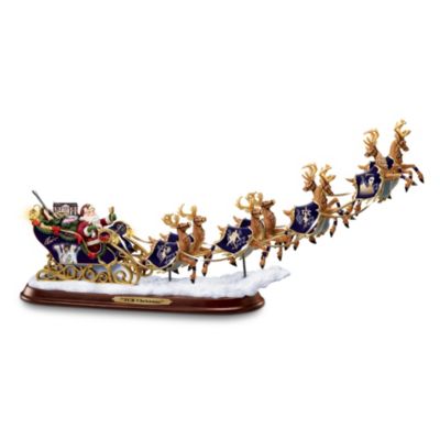 As millions of his fans already know, one of Elvis's passions was transportation, including cars, motorcycles and trains! Now, memories of the Ultimate Entertainer take a Christmas Eve ride on a high-flying form of transportation with none other than Santa himself. Make your holidays rock with the first-ever collectible Elvis TCB Christmas illuminated sleigh figurine decorated with full-color portraits of the King of Rock 'n' Roll&reg; in his trademark "Peacock" performance jumpsuit, classic "EP" emblems and more.Take care of holiday business with this memorable handcrafted limited-edition handcrafted Elvis Presley tribute, available only from The Bradford Editions. The glowing LED lights inside the lanterns on this Elvis TCB Christmas illuminated sleigh figurine light up with the flip of a switch. Santa's bag of goodies is stuffed with gifts Elvis will love, including a rockin' guitar and a pink Cadillac&reg;. Makes a unique holiday tabletop decoration or collectible Elvis gift. Powerful demand is expected, and you won't want to miss out. Order now!