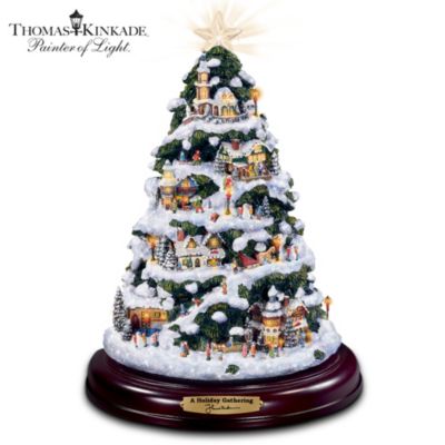 From festive celebrations to special times with family, the holiday season holds blessings for each of us. Now, the Painter of Light puts his "spin" on the holidays with a Thomas Kinkade Christmas tree. Exclusively from The Bradford Editions, this yuletide collectible is a showcase for intricate winter scenes, populated with villagers, lampposts, petite evergreens, and cozy buildings creating an entire Thomas Kinkade Christmas village in one mini-masterpiece.Entirely handcrafted and hand-painted, this prized collectible comes to life at the touch of a button - a warm glow illuminates from every building, a medley of twelve holiday songs begin, and the tree rotates atop its handsome base. A glowing crystalline tree topper and sparkling snow accents add a finishing touch, making this a magnificent Thomas Kinkade holiday home decoration. Don't miss this one-of-a-kind Christmas vision and celebration. Order now!