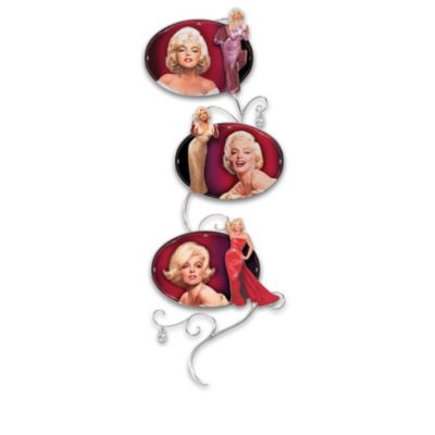 With her hair shining like spun gold and eyes as blue as sapphires, Marilyn Monroe is a legendary beauty. Now, you can admire her style in a collectible Marilyn Monroe wall decor collection that celebrates a glamour as rare as the finest jewels. This exquisite collection begins with Issue One, Dazzling Diamonds. Soon, your collection continues with Issue Two, Golden Glamour, Issue Three, Scarlet Passion and Issue Four, Display Rack, each a separate issue to follow.Salute a shining star with this breathtaking collection of limited-edition Platinum Perfection Marilyn wall decor, only from The Bradford Exchange. Each issue in this collection includes a beautiful portrait by famed artist Chris Notarile on a porcelain Marilyn Monroe collector plate and a graceful porcelain silhouette of Marilyn. The elegant scrollwork display is adorned with two simulated diamonds. Strong demand is expected, and you won't want to miss out on this tribute to the marvelous Marilyn we know and love. Order now!