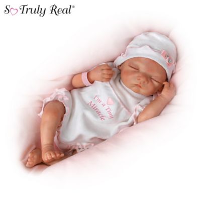 You'll fall instantly in love with these precious "early arrival" newborns the moment you first see them and hold them! These lifelike baby dolls by Master Doll Artist Waltraud Hanl are yours in this So Truly Real&reg; baby doll collection that proves life's greatest gifts come in the smallest packages, available exclusively from The Ashton-Drake Galleries. Start your collection with Issue One, I'm a Tiny Miracle. Soon, your collection continues with Issue Two, I'm Truly a Special Blessing, Issue Three, The Best Gifts Are From Above, and additional collectible baby dolls, each a separate issue to follow.This amazingly lifelike baby doll collection is handcrafted with our own baby-soft RealTouch&reg; vinyl skin, delicately hand-painted features and hand-applied hair. Each little one arrives wearing a darling one-piece outfit adorned with his or her nickname, a baby cap, a tiny disposable diaper, and a hospital bracelet you can personalize for each baby. Plus, these little cuties can be swaddled in their very own hospital baby blankets, included with each doll. This collectible Early Arrivals baby doll collection is the first collection of its type from artist Waltraud Hanl, so demand is likely to be high. Bring them into your home when you order now!