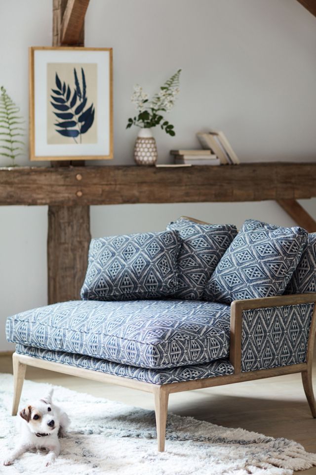 Indigo print on chaise chair and fern wall art in a rustic modern room - Anthropologie. #modernrustic #indigoblue #interiordesign