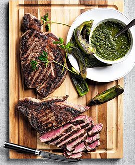 grilled steak with chimichurri and charred peppers