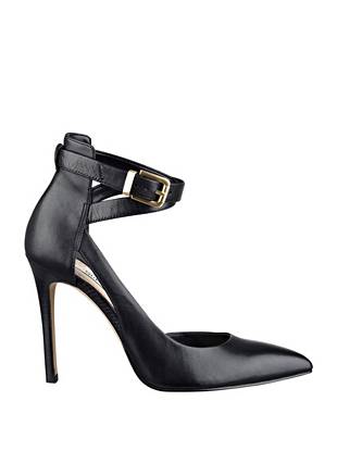 A seductive pointed toe and open instep design make these pumps the ...
