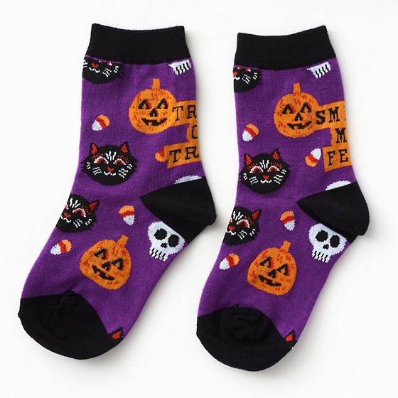 Black and purple kid's socks featuring trick or treat, smell my feet message.
