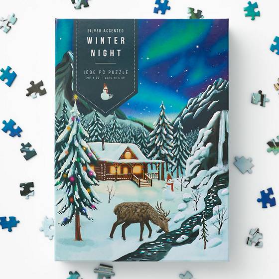 National Parks Puzzle by Cavallini and Co surrounded by holiday decor.