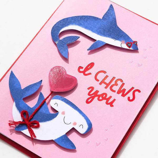 Valentine's Day greeting card featuring sharks and hearts that reads I Chews You