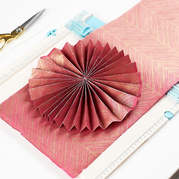 Red rosette- folded flower with red paper- use magazines to make them- kids activities blog