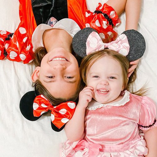 Young girl and toddler dressed as Minnie Mouse