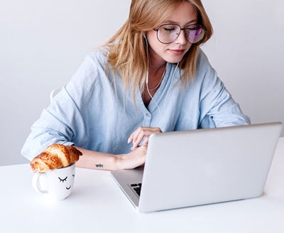 Women on laptop with a cup of tea