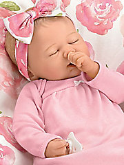 Her mouth is designed to fit her thumb or included pacifier